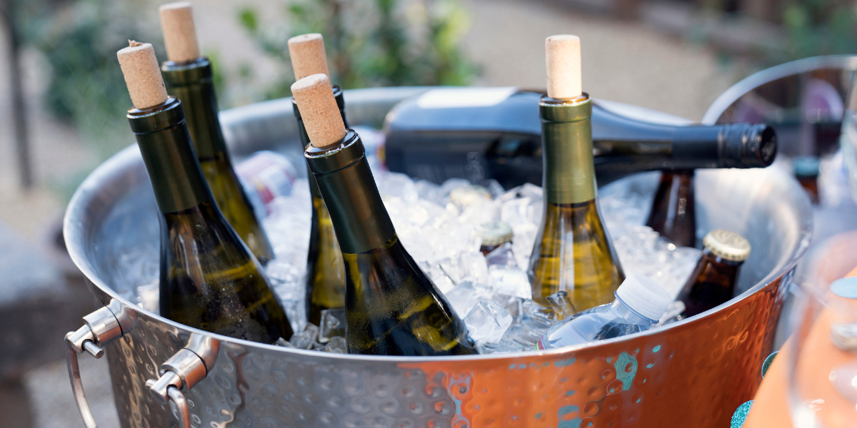 a large bucket of ice with several wine bottles in it