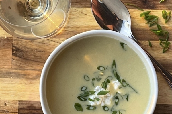 Image of corn soup with a glass of wine from top view
