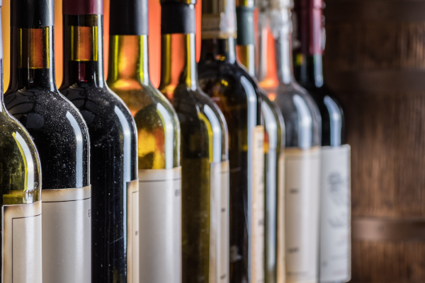 A lineup of various wine bottles on a bar