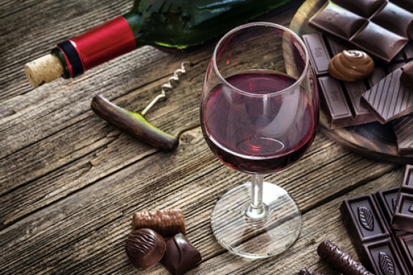 Wine and chocolate on wooden table