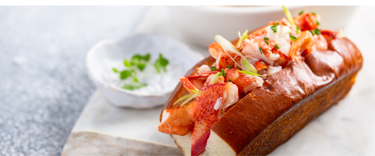 A lobster roll on a white plate