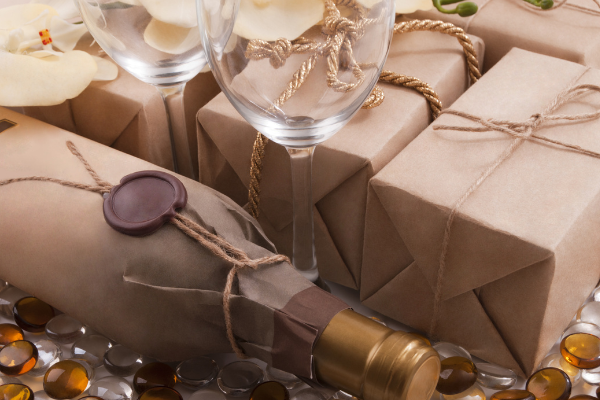 paper wrapped gifts beside a wine bottle