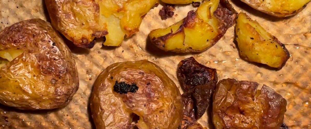 overhead of crispy potatoes on a baking tray
