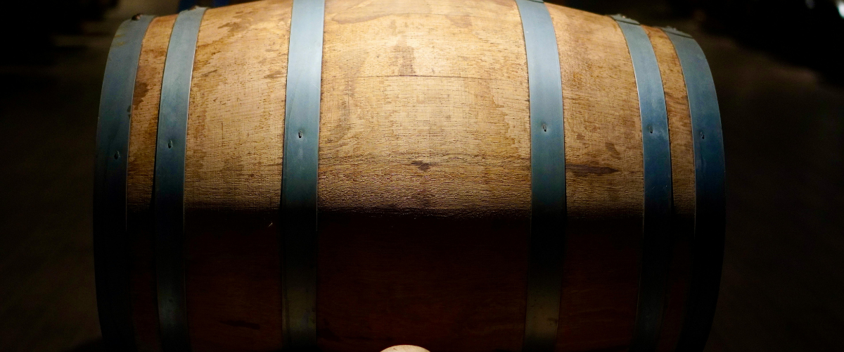 close up of a wine barrel in shadow