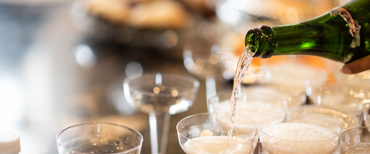 Coups being filled with champagne