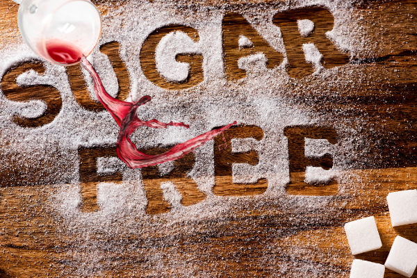 sugar free written in sugar with red wine pouring out of a glass