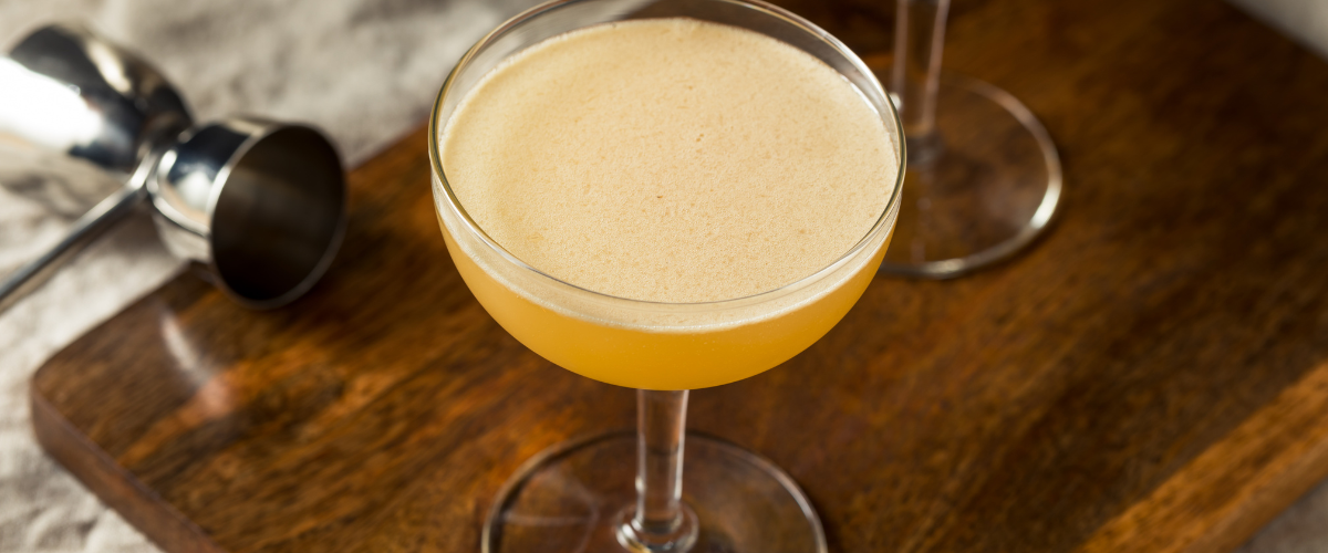 Overhead view yellow-orange cocktail in a coup