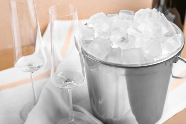 a wine bottle in a bucket of ice