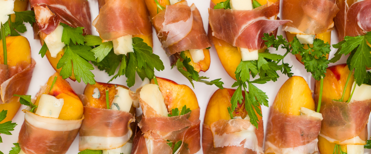 Grilled peaches wrapped in proscuitto