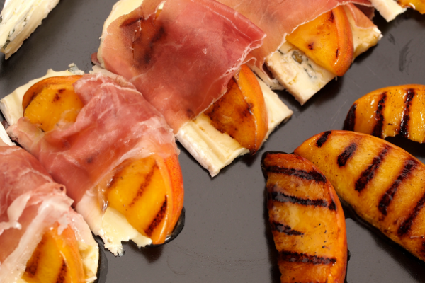 Grilled peaches wrapped in proscuitto