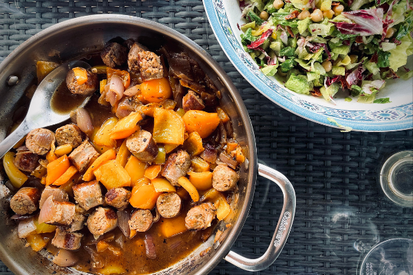 overhead view of sausage and peppers in a pan