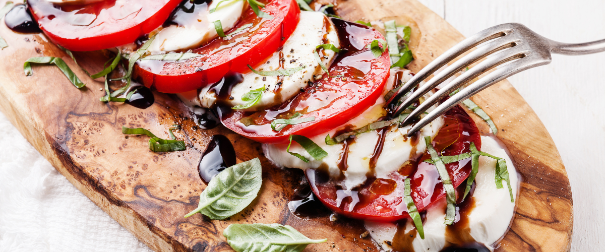 Caprese salad close up on an olive wood board