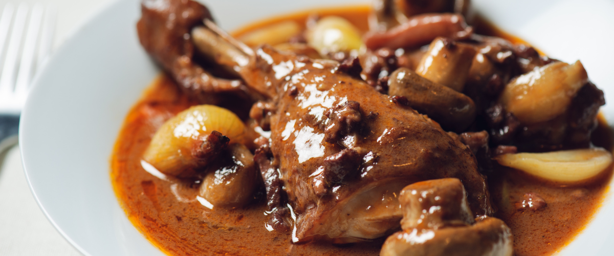 close up on a plate of coq au vin