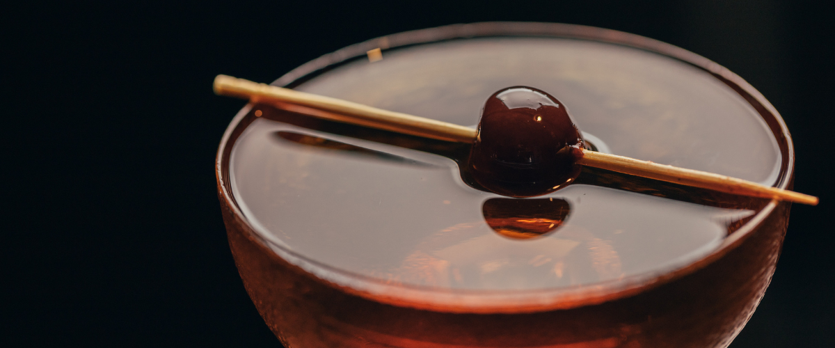 Close up on a cherry in a cocktail