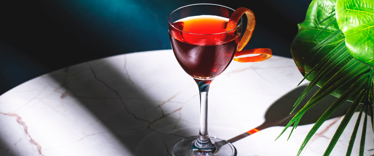 red bijou cocktail in the sun