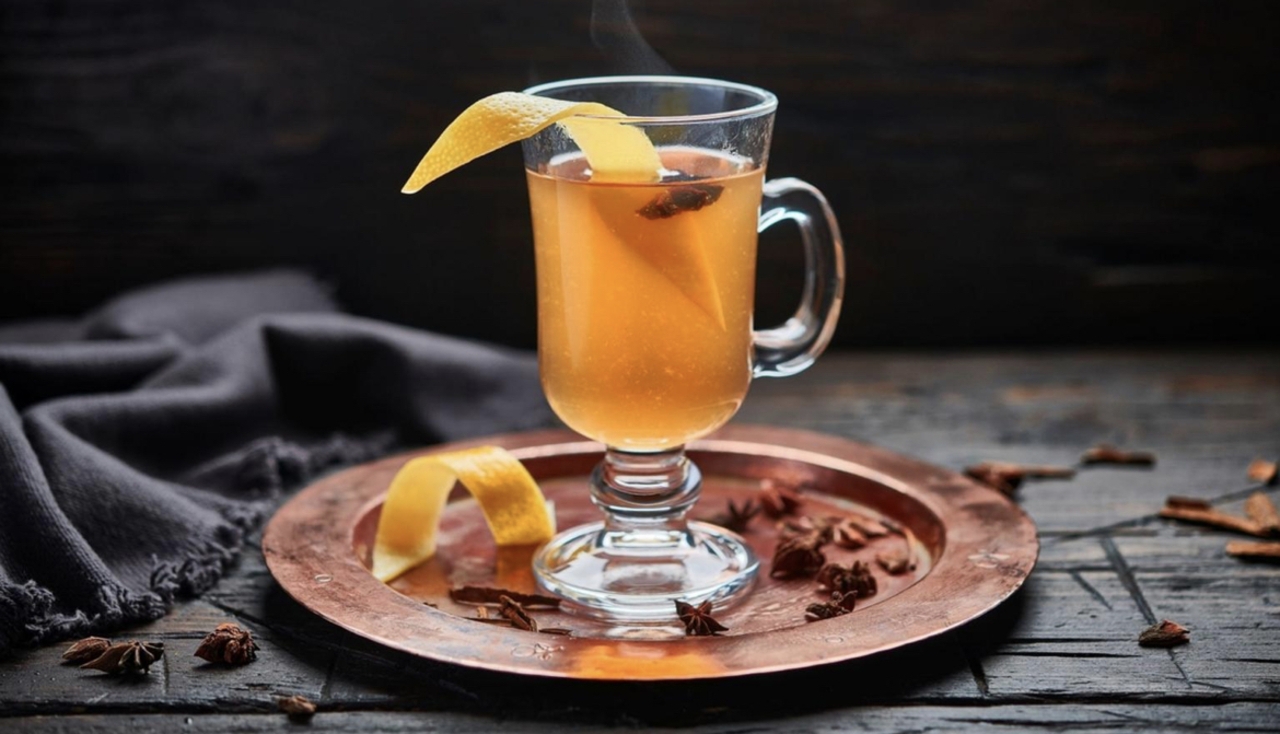Clear glass mug with steaming hot toddy
