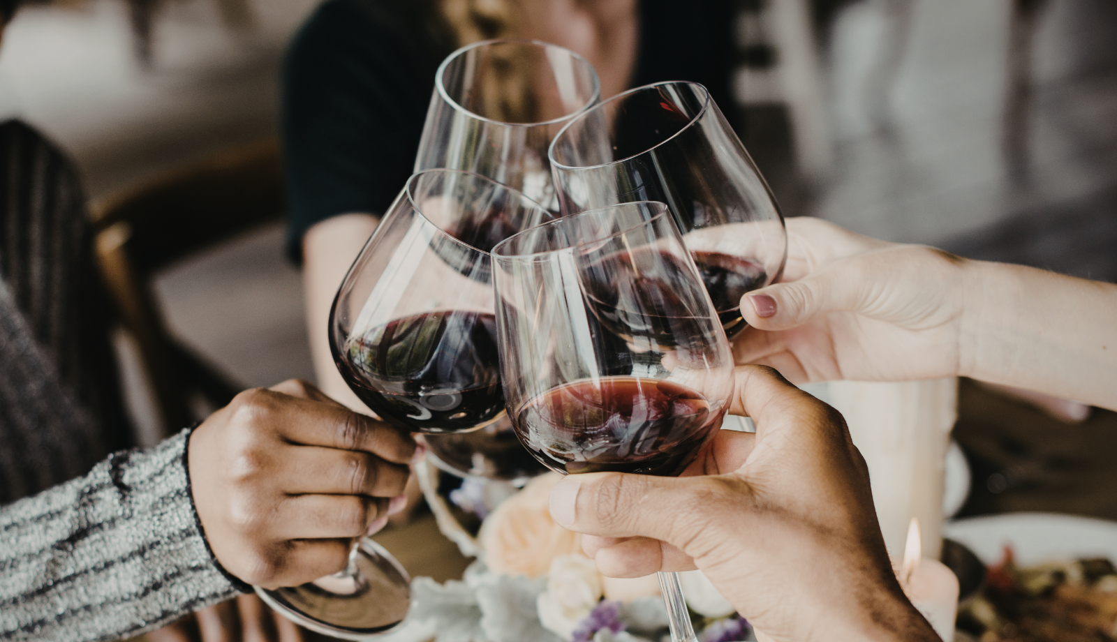 4 red wine glasses clinking